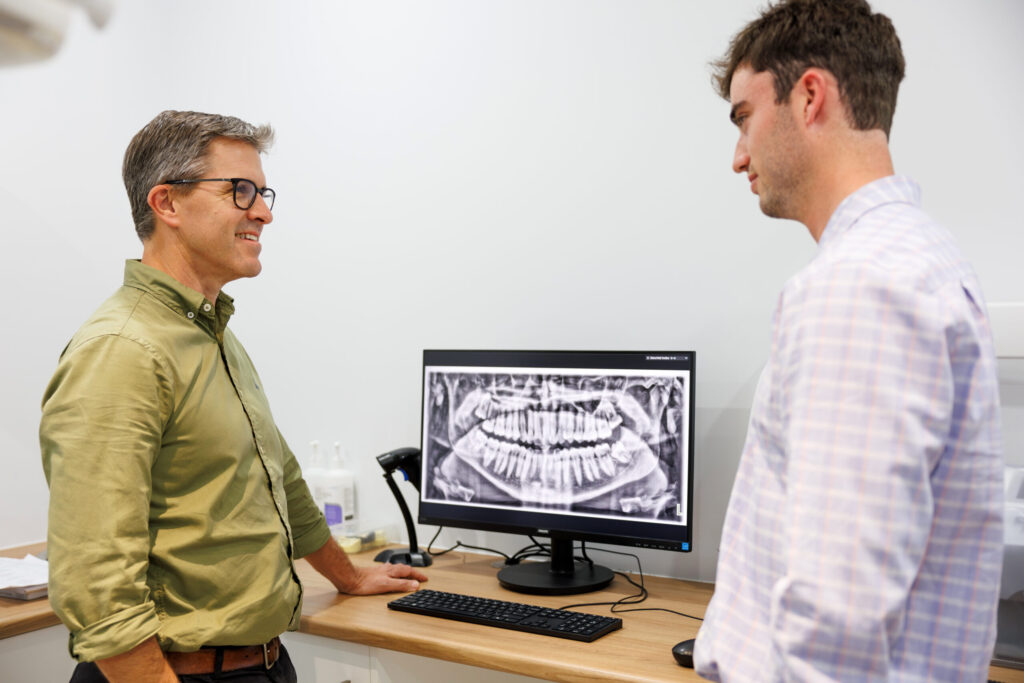 Dr Crichton and Dr Monte discussing a x-ray for dentures